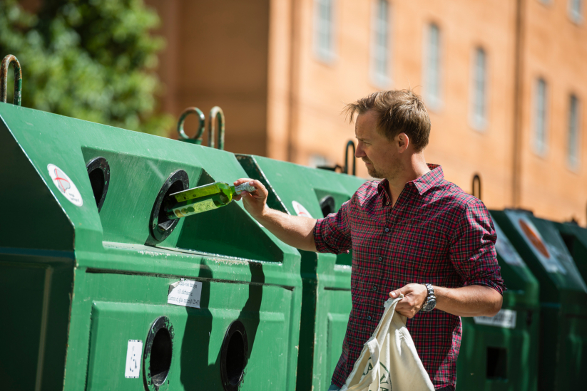 Man recycling bottles in Sweden